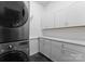 Laundry area with gray washer and dryer, white cabinets, and sleek countertops at 1430 Mollys Backbone Rd, Catawba, NC 28609