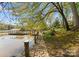 Scenic walkway leading to a private dock with covered boat slip, surrounded by lush greenery and lake views at 1430 Mollys Backbone Rd, Catawba, NC 28609