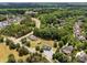Aerial view of home with nearby neighborhood and wooded backdrop at 14532 E Rocky River Rd, Davidson, NC 28036