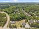 Aerial view of a neighborhood featuring mature trees and a winding road at 14532 E Rocky River Rd, Davidson, NC 28036