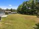 Expansive backyard featuring lush green grass, mature trees, and plenty of space for outdoor activities at 14532 E Rocky River Rd, Davidson, NC 28036