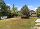 Large grass backyard with privacy fence and a shed near treeline at 14532 E Rocky River Rd, Davidson, NC 28036