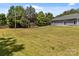 Spacious lawn behind a home with a gray exterior and privacy fence at 14532 E Rocky River Rd, Davidson, NC 28036