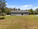 Home with a gray exterior and sliding glass door to the backyard at 14532 E Rocky River Rd, Davidson, NC 28036