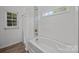 Bathroom featuring a tub and shower with mosaic tile accent at 14532 E Rocky River Rd, Davidson, NC 28036