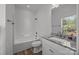 Bathroom featuring a vanity with granite countertops and a shower-tub combo at 14532 E Rocky River Rd, Davidson, NC 28036