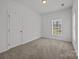 Bedroom with a window offering natural light at 14532 E Rocky River Rd, Davidson, NC 28036