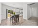 Dining area with modern table, stylish chairs, and sliding glass doors leading to the backyard at 14532 E Rocky River Rd, Davidson, NC 28036