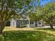 Quaint home featuring gray siding, a white picket fence, and lush landscaping, creating a serene setting at 14532 E Rocky River Rd, Davidson, NC 28036