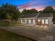 Charming home featuring a gravel driveway, covered front porch, fresh landscaping, and inviting curb appeal at 14532 E Rocky River Rd, Davidson, NC 28036