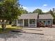 Charming home showcasing a gravel driveway, a cozy front porch with a white picket fence, and fresh landscaping at 14532 E Rocky River Rd, Davidson, NC 28036