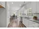 Open kitchen and dining area with modern fixtures, white cabinetry, and seamless access to the outdoors at 14532 E Rocky River Rd, Davidson, NC 28036