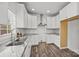 Updated kitchen with white cabinetry, granite countertops, stainless steel sink, and lots of natural light at 14532 E Rocky River Rd, Davidson, NC 28036