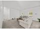 Bright living room with plush carpeting, neutral paint, and abundant natural light from large windows at 14532 E Rocky River Rd, Davidson, NC 28036