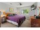 Cozy bedroom featuring a ceiling fan, television, and a window with a view of greenery at 1506 Crestdale Rd, Rock Hill, SC 29732
