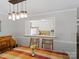 Bright dining room with view into the kitchen, wood floors, and decorative light fixture at 1506 Crestdale Rd, Rock Hill, SC 29732