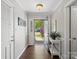 Bright foyer featuring hardwood floors, a white console table, and an open doorway to the outside at 1506 Crestdale Rd, Rock Hill, SC 29732