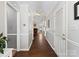 Long hallway with hardwood floors, white trim, and multiple doorways leading to various rooms at 1506 Crestdale Rd, Rock Hill, SC 29732