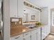 Well-lit kitchen featuring white cabinets, stainless double sink, and a decorative backsplash at 1506 Crestdale Rd, Rock Hill, SC 29732