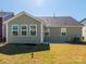 Backyard of home with a green lawn, with a view of the home's exterior, and a concrete patio at 1516 Laggan Ln, Indian Trail, NC 28079