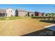 Large backyard of home with a well kept lawn and privacy fencing, with neighboring houses visible at 1516 Laggan Ln, Indian Trail, NC 28079