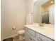 Bathroom featuring a white vanity with a sink and mirror, alongside a toilet and towel rack at 1516 Laggan Ln, Indian Trail, NC 28079