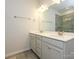 Well-lit bathroom with dual sinks, vanity with cabinet space, and a glass-enclosed shower at 1516 Laggan Ln, Indian Trail, NC 28079