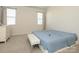 Simple bedroom featuring neutral walls, plush carpet, and natural light from a pair of windows at 1516 Laggan Ln, Indian Trail, NC 28079