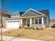 Charming home with a welcoming porch, manicured lawn, and two-car garage, perfect for modern living at 1516 Laggan Ln, Indian Trail, NC 28079