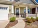 Inviting front porch with stone accents and a cozy seating area, enhancing curb appeal at 1516 Laggan Ln, Indian Trail, NC 28079