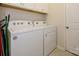 Laundry room with white washer and dryer, white cabinets, and access to the utility closet at 1516 Laggan Ln, Indian Trail, NC 28079