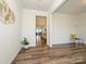 Spacious living room with wood-look floors, neutral walls, and seamless flow to the dining and kitchen areas at 1516 Laggan Ln, Indian Trail, NC 28079