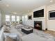 Bright living room with fireplace, plush seating, and natural light from large windows at 1516 Laggan Ln, Indian Trail, NC 28079