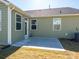 Backyard patio features a view of the house and lawn, and a sliding glass door for access at 1516 Laggan Ln, Indian Trail, NC 28079