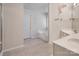 Bright bathroom featuring a soaking tub, double vanity, and neutral tile floor at 16219 Long Talon Way, Charlotte, NC 28273