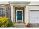 Charming home entrance featuring a blue front door framed by stone and white pillars at 16219 Long Talon Way, Charlotte, NC 28273