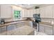 Well-lit kitchen featuring stainless steel appliances, granite countertops and light wood cabinetry at 16219 Long Talon Way, Charlotte, NC 28273