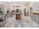 Modern kitchen boasts an island, gray cabinets, stainless appliances, and stylish tile flooring at 16219 Long Talon Way, Charlotte, NC 28273