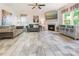 Bright living room features tile floors, modern fireplace, neutral decor, and backyard view at 16219 Long Talon Way, Charlotte, NC 28273