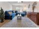 Comfortable living room with blue sectional sofa, area rug, and wooden chest of drawers at 16219 Long Talon Way, Charlotte, NC 28273