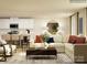 Bright living room featuring a modern sectional sofa, stylish coffee table, and an open-concept kitchen with bar seating at 1627 Spring Lot Dr, Edgemoor, SC 29712