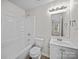Clean white bathroom with a shower-tub combo, a vanity with sink, and a large mirror at 1762 Tate Rd, Rock Hill, SC 29732