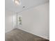 A carpeted bedroom with neutral walls and a window that looks onto the property at 1762 Tate Rd, Rock Hill, SC 29732