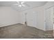 Spacious bedroom featuring a ceiling fan, ensuite bathroom, and plush neutral carpeting at 1762 Tate Rd, Rock Hill, SC 29732