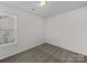 A neutral bedroom has plush carpet and a window that looks onto the property at 1762 Tate Rd, Rock Hill, SC 29732