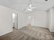Bright bedroom featuring a ceiling fan, ensuite bathroom, and plush neutral carpeting at 1762 Tate Rd, Rock Hill, SC 29732