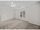Bright bedroom featuring a ceiling fan, large window, and plush neutral carpeting at 1762 Tate Rd, Rock Hill, SC 29732