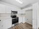 Bright kitchen featuring stainless appliances, white cabinetry, and wood flooring at 1762 Tate Rd, Rock Hill, SC 29732