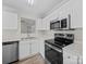 Well-appointed kitchen featuring stainless appliances, white cabinetry, and wood flooring at 1762 Tate Rd, Rock Hill, SC 29732