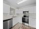 Modern kitchen featuring stainless appliances, white cabinetry, and wood flooring at 1762 Tate Rd, Rock Hill, SC 29732